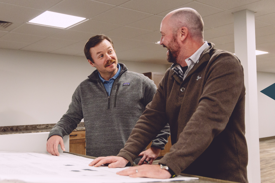 Vemco sales engineers discussing HVAC blueprints